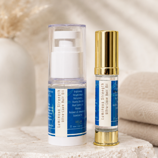Luminous Strength Ultra-Luxe Hair Oil en dos presentaciones sobre mesa cerca de una ventana con luz natural.